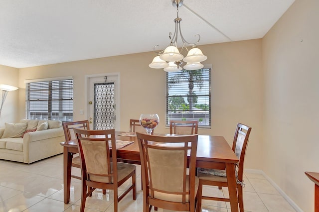 tiled dining area with an inviting chandelier