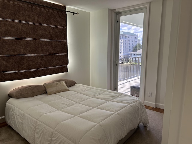 bedroom featuring access to exterior and wood-type flooring