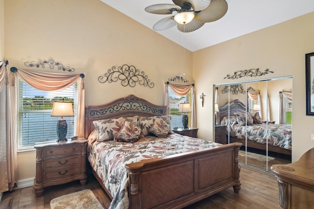 bedroom with ceiling fan, wood-type flooring, a closet, and lofted ceiling