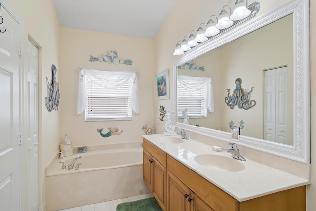 bathroom featuring a bath, tile patterned floors, and vanity