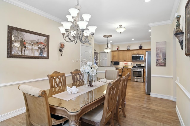 dining area with light wood-type flooring, an inviting chandelier, and ornamental molding