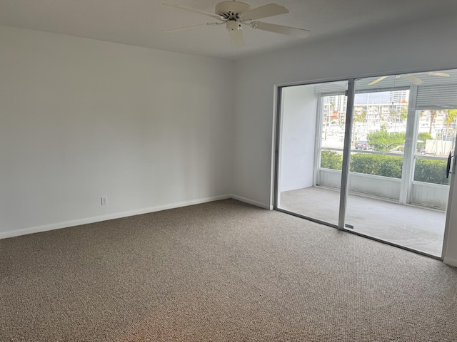 spare room with ceiling fan and carpet floors