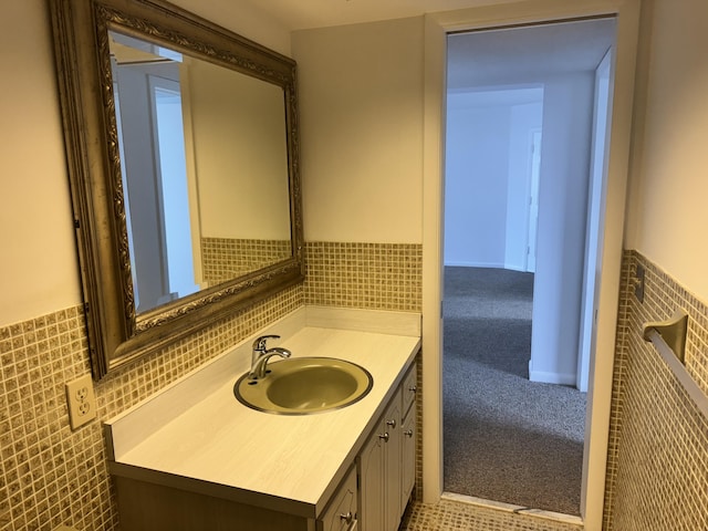 bathroom featuring tile walls and vanity