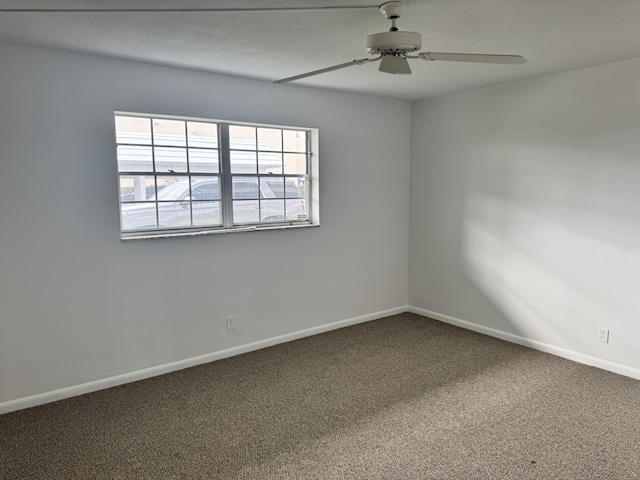 unfurnished room featuring ceiling fan and carpet