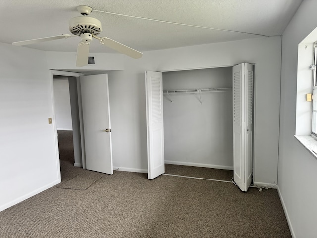 unfurnished bedroom featuring ceiling fan and dark colored carpet