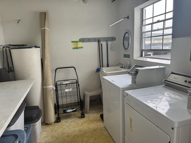 washroom with sink and washing machine and clothes dryer