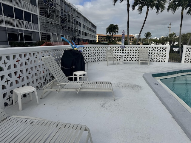 view of patio / terrace with grilling area and a community pool