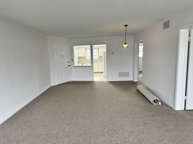 unfurnished room with light carpet