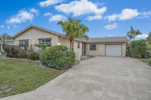 ranch-style home featuring a garage and a front yard