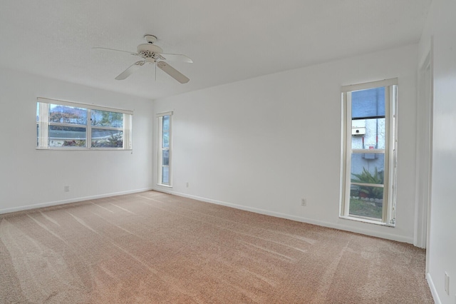 carpeted spare room with ceiling fan