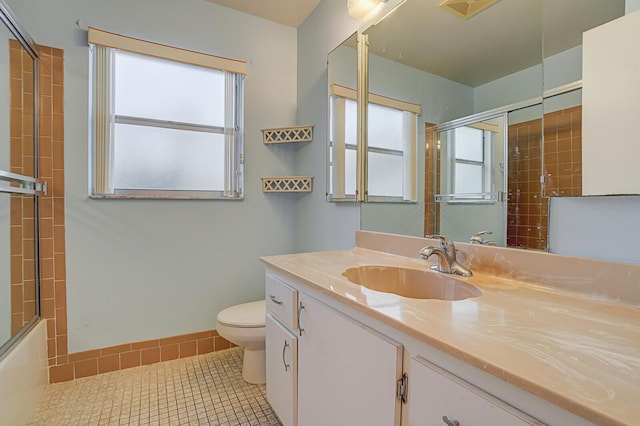 full bathroom with toilet, a wealth of natural light, tile patterned floors, and vanity