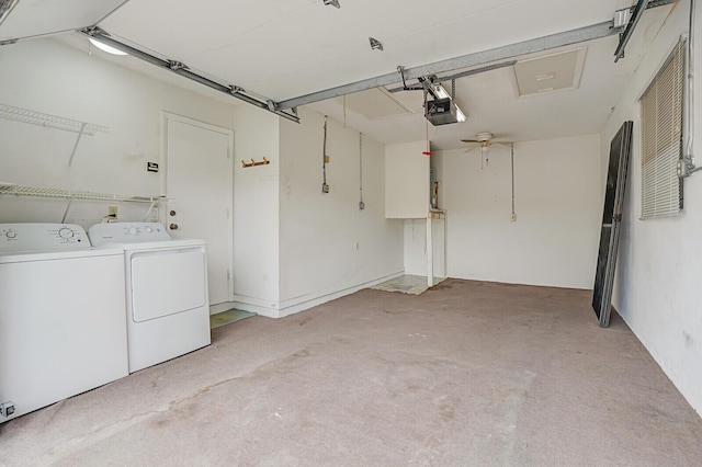 garage with a garage door opener and washer and dryer