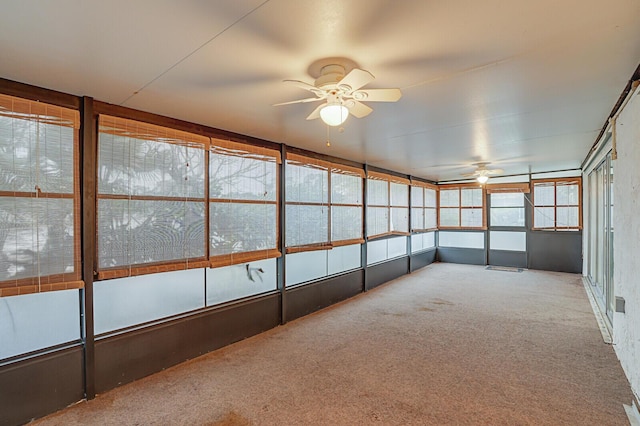 unfurnished sunroom with ceiling fan