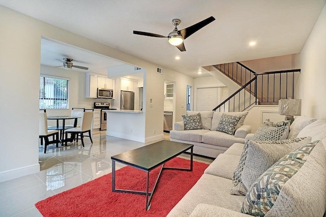 living room featuring ceiling fan and light tile patterned flooring