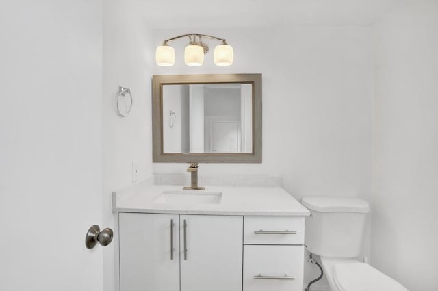 bathroom with vanity and toilet