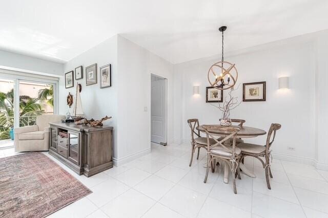 tiled dining space featuring a chandelier