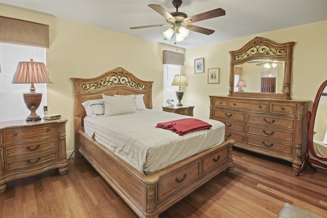 bedroom with ceiling fan and dark wood-type flooring