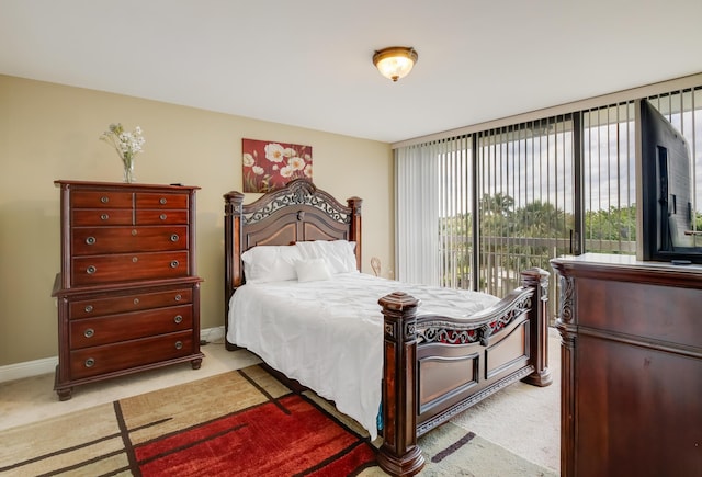 bedroom with access to exterior and light colored carpet