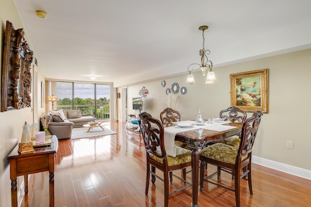 dining area featuring light hardwood / wood-style floors and floor to ceiling windows