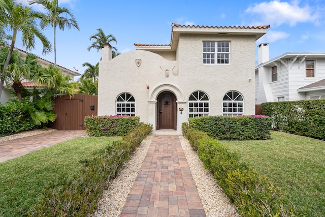 mediterranean / spanish house with a front lawn