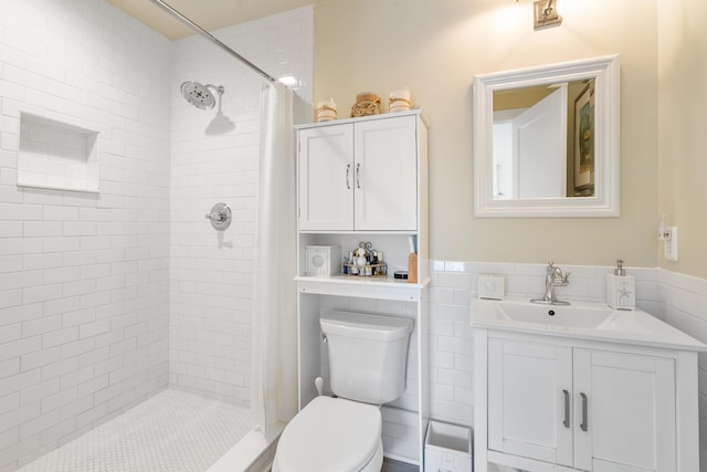 bathroom with toilet, tile walls, a shower with curtain, and vanity