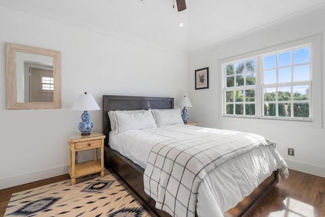 bedroom with ceiling fan, dark hardwood / wood-style floors, crown molding, and lofted ceiling