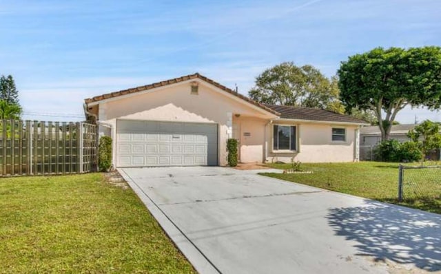 view of front of property featuring a front yard and a garage