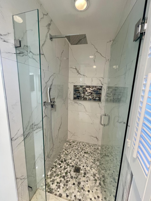 bathroom with a shower with shower door