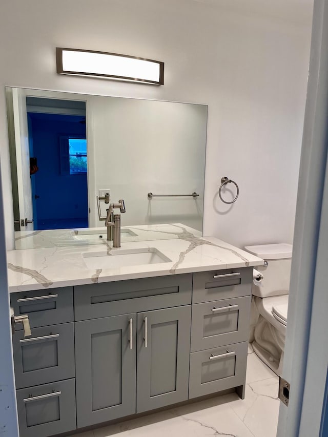 bathroom with toilet and vanity