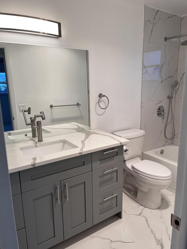 full bathroom with toilet, vanity, and tiled shower / bath