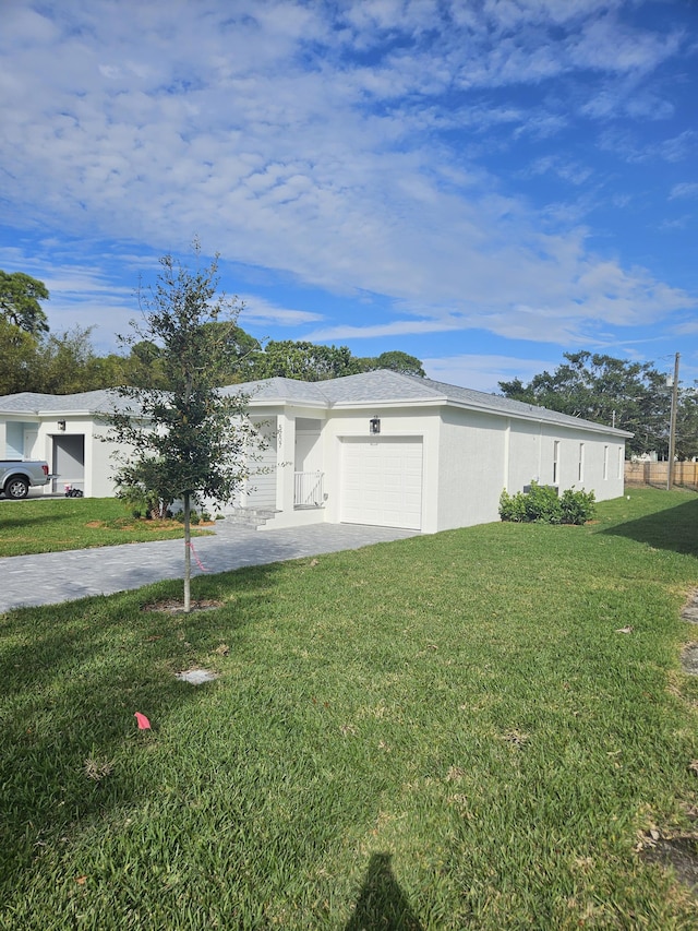 exterior space featuring a front lawn and a garage