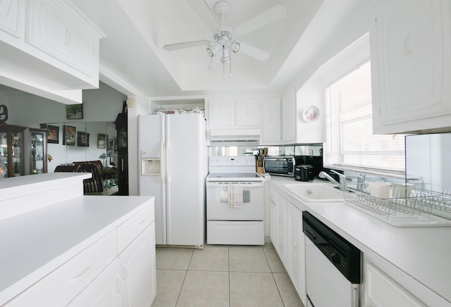 kitchen with light tile patterned floors, sink, white cabinets, and white appliances