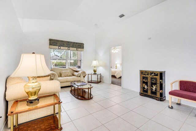 kitchen with light tile patterned floors, kitchen peninsula, white appliances, lofted ceiling, and sink