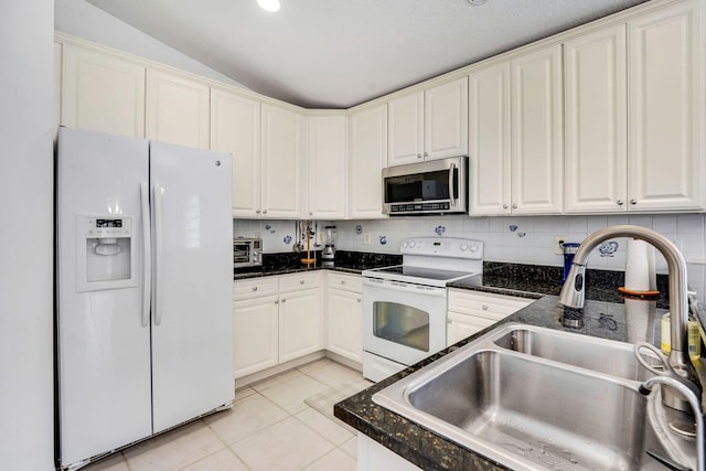 kitchen with light tile patterned floors, backsplash, white appliances, lofted ceiling, and sink