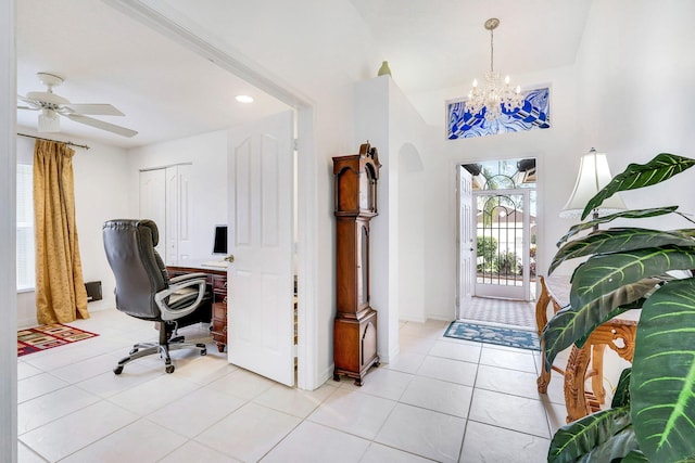 tiled home office with ceiling fan with notable chandelier