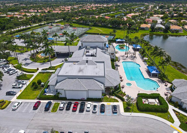 view of pool with a water view and a patio area