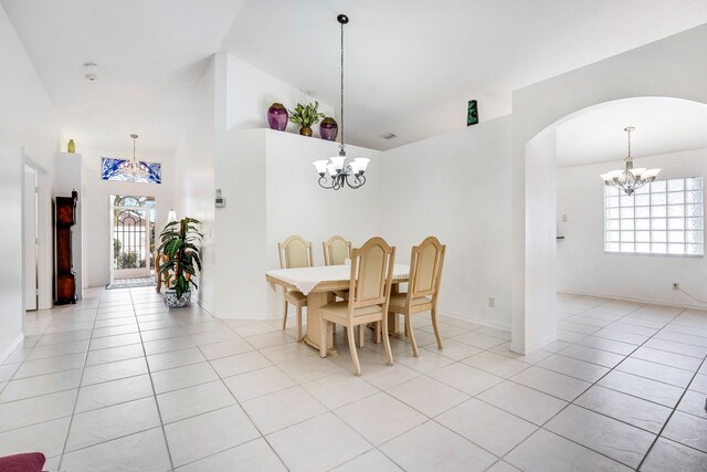 living room featuring light tile patterned floors and ceiling fan with notable chandelier