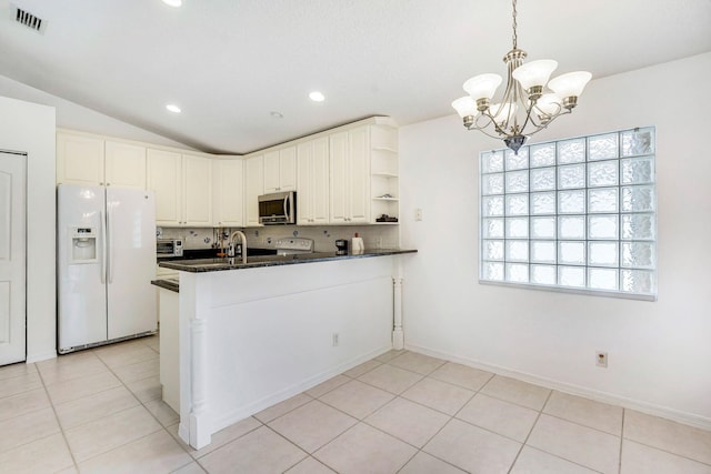 kitchen with vaulted ceiling, kitchen peninsula, hanging light fixtures, white refrigerator with ice dispenser, and light tile patterned floors