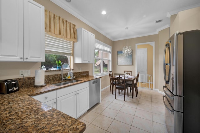 kitchen featuring light tile patterned floors, white cabinetry, stainless steel appliances, pendant lighting, and sink