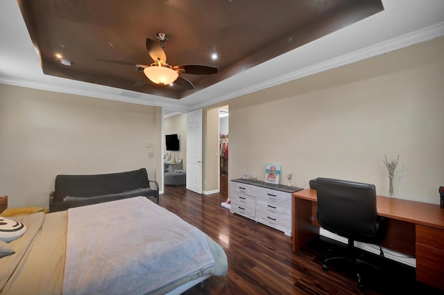 bedroom featuring ceiling fan, dark hardwood / wood-style flooring, ornamental molding, and a tray ceiling