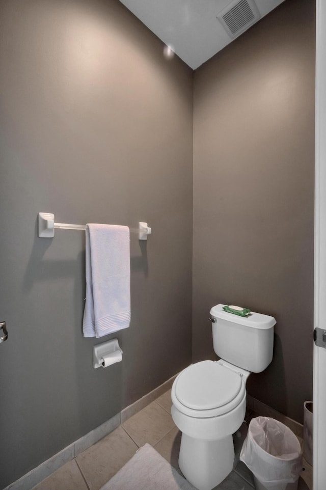 bathroom with toilet and tile patterned flooring