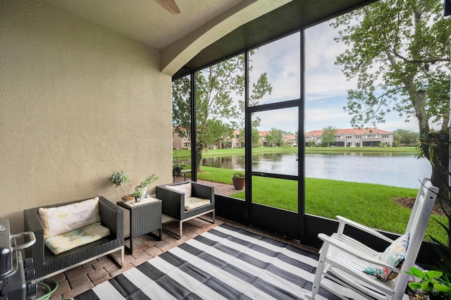 sunroom / solarium with a wealth of natural light and a water view