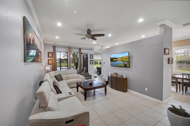 tiled living room with ceiling fan and crown molding