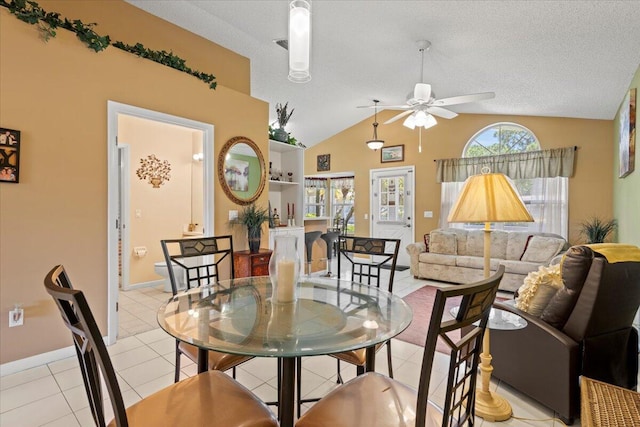 living room featuring a textured ceiling, ceiling fan, light tile patterned flooring, and lofted ceiling