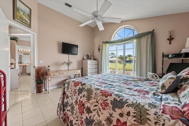 tiled bedroom with a textured ceiling, ceiling fan, and access to outside