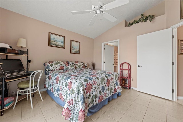 bedroom featuring ceiling fan, a textured ceiling, lofted ceiling, and light tile patterned flooring