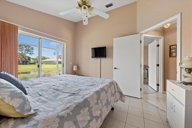 bedroom featuring ceiling fan, light tile patterned flooring, access to outside, and visible vents