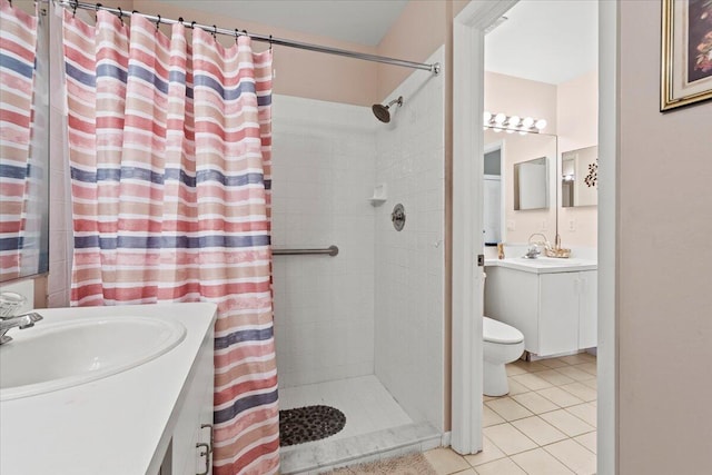 bathroom featuring toilet, tile patterned floors, vanity, and curtained shower