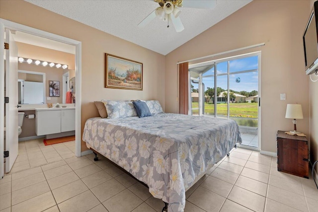 bedroom with ceiling fan, connected bathroom, light tile patterned flooring, access to exterior, and vaulted ceiling