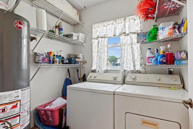 clothes washing area with gas water heater and washing machine and dryer